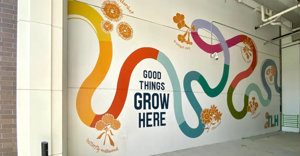 Bold new mural blooms near Cascades Park this week