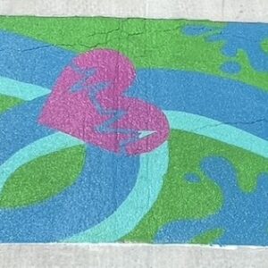 Close up picture of painted heart and swirls on crosswalk